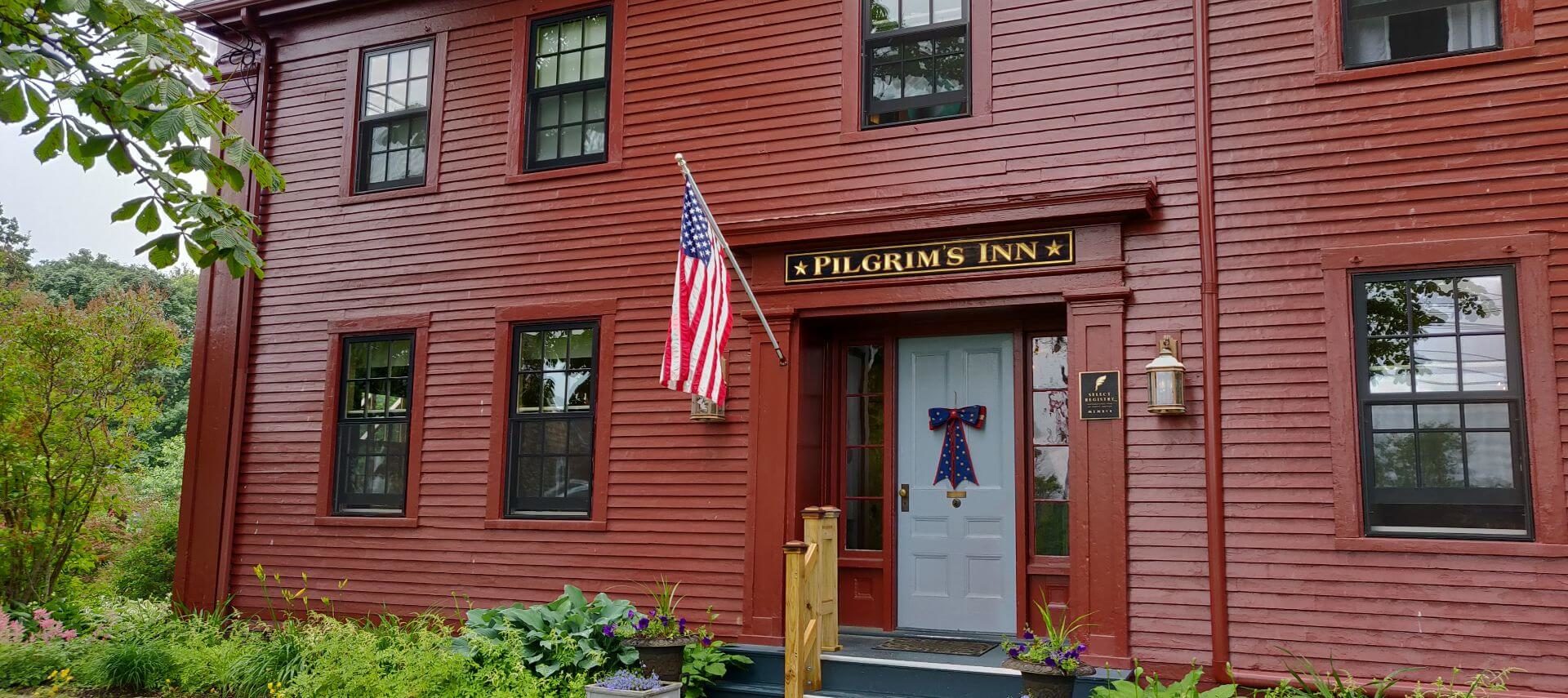 Pilgrim's Inn entrance with flag and July 4th decoration
